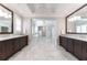 Bright bathroom featuring marble flooring, dual vanities, a walk-in shower and separate tub at 44 Barbara Ln, Atlanta, GA 30327