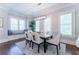 Dining room with modern lighting, white chairs, and a built-in window bench at 44 Barbara Ln, Atlanta, GA 30327