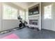 Sunlit exercise room with fireplace, tile flooring, and multiple windows at 44 Barbara Ln, Atlanta, GA 30327