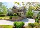 Exterior of a two-story home with a spacious driveway, lush landscaping, and an attached garage at 44 Barbara Ln, Atlanta, GA 30327