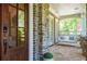 Inviting front porch with stone accents, a swing, and comfortable seating at 44 Barbara Ln, Atlanta, GA 30327