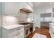 Chef's kitchen featuring stainless steel appliances, marble countertops, and custom cabinetry at 44 Barbara Ln, Atlanta, GA 30327