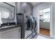 Well-equipped laundry room with modern washer and dryer and ample storage, adjacent to custom closet at 44 Barbara Ln, Atlanta, GA 30327