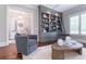 Cozy living room featuring custom built-ins, hardwood floors, and neutral furniture at 44 Barbara Ln, Atlanta, GA 30327