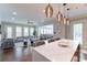 Open-concept living area featuring hardwood floors, bar with pendant lights, and large windows at 44 Barbara Ln, Atlanta, GA 30327