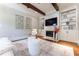 Cozy living room featuring fireplace, built-in shelving, hardwood floors, and ample natural light at 44 Barbara Ln, Atlanta, GA 30327