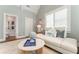 Cozy living room with comfortable seating, bright windows, and an inviting aesthetic, adjacent to bathroom at 44 Barbara Ln, Atlanta, GA 30327