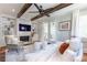 Relaxing living room with wood beam ceiling, fireplace, built-in bookshelves, and outdoor access at 44 Barbara Ln, Atlanta, GA 30327