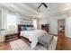 Well-lit main bedroom with tray ceilings, white curtains, and decorative pillows at 44 Barbara Ln, Atlanta, GA 30327