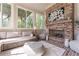 Cozy sun room with brick fireplace, neutral furniture, and views of nature at 44 Barbara Ln, Atlanta, GA 30327