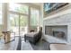 Bright sunroom with wicker furniture, fireplace, and large windows overlooking outdoor deck and backyard at 44 Barbara Ln, Atlanta, GA 30327