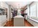 Spacious walk-in closet with island, window seat, custom cabinetry, and hardwood floors at 44 Barbara Ln, Atlanta, GA 30327