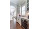 Elegant wet bar with marble countertop, beverage fridge and custom white cabinets at 44 Barbara Ln, Atlanta, GA 30327