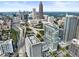 Expansive aerial shot of the city featuring skyscrapers, highways, and lush greenery, highlighting the vibrant urban landscape at 45 Ivan Allen Jr Nw Blvd # 1702, Atlanta, GA 30308