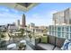 Enjoy breathtaking city views from this condo balcony with modern seating at 45 Ivan Allen Jr Nw Blvd # 1702, Atlanta, GA 30308