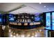 Sleek bar area boasts a curved counter with seating, multiple TVs, and a fully stocked bar with modern pendant lighting at 45 Ivan Allen Jr Nw Blvd # 1702, Atlanta, GA 30308