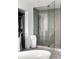 Modern bathroom featuring a glass-enclosed shower, tile flooring, and a walk-in closet at 45 Ivan Allen Jr Nw Blvd # 1702, Atlanta, GA 30308