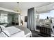 Bedroom featuring city views, modern chandelier, and access to private outdoor balcony at 45 Ivan Allen Jr Nw Blvd # 1702, Atlanta, GA 30308