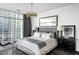 Modern bedroom featuring city views, a decorative chandelier and large picture window at 45 Ivan Allen Jr Nw Blvd # 1702, Atlanta, GA 30308