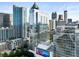 Modern high-rise condo building with glass facade, city skyline, and rooftop pool at 45 Ivan Allen Jr Nw Blvd # 1702, Atlanta, GA 30308