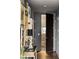 Hallway with dark wood door, patterned floor, and decorative art pieces that add character to the space at 45 Ivan Allen Jr Nw Blvd # 1702, Atlanta, GA 30308