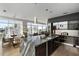 Open-concept kitchen with stainless appliances, granite counters, and cityscape view from large windows at 45 Ivan Allen Jr Nw Blvd # 1702, Atlanta, GA 30308