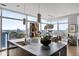 A modern kitchen with a large island, sink, bar, and beautiful city views from expansive windows at 45 Ivan Allen Jr Nw Blvd # 1702, Atlanta, GA 30308