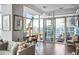 Bright living area featuring large windows, a comfortable seating area, and balcony access with city views at 45 Ivan Allen Jr Nw Blvd # 1702, Atlanta, GA 30308