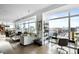 Open-concept living space with modern furniture, large windows with city views, and a stylish home office setup at 45 Ivan Allen Jr Nw Blvd # 1702, Atlanta, GA 30308