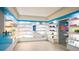 Bright spa features white shelving stocked with products under blue trim, with a glass door entrance to the service area at 45 Ivan Allen Jr Nw Blvd # 1702, Atlanta, GA 30308