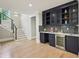 Finished basement wet bar with a wine fridge, custom cabinets, and quartz countertops at 1059 Woodland Ave, Atlanta, GA 30316