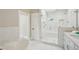 Elegant bathroom with a soaking tub and walk-in shower, white marble counters and double sink vanity at 1059 Woodland Ave, Atlanta, GA 30316