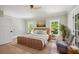 Serene bedroom featuring hardwood floors, natural light, and neutral decor at 1059 Woodland Ave, Atlanta, GA 30316