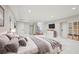 Spacious bedroom with recessed lighting, an adjacent staircase, a tv, and access to built-in shelving at 1059 Woodland Ave, Atlanta, GA 30316