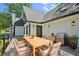 Back deck with grilling station, outdoor table and seating, and metal railing at 1059 Woodland Ave, Atlanta, GA 30316