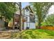 Beautiful home exterior features multiple decks, lush lawn, mature trees and white exterior at 1059 Woodland Ave, Atlanta, GA 30316