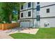 A pristine, white-exterior home features a spacious two-car garage and well-manicured lawn at 1059 Woodland Ave, Atlanta, GA 30316