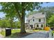 Charming two-story home with a manicured lawn, stone walkway, and a lovely pergola covered porch at 1059 Woodland Ave, Atlanta, GA 30316