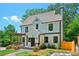 Charming two-story home with a manicured lawn, stone walkway, and a lovely pergola covered porch at 1059 Woodland Ave, Atlanta, GA 30316