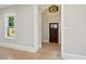 Bright foyer featuring hardwood floors, a modern light fixture and front door view at 1059 Woodland Ave, Atlanta, GA 30316