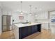 Bright kitchen with a large center island, stainless steel appliances, and subway tile backsplash at 1059 Woodland Ave, Atlanta, GA 30316