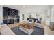 Open-concept living room featuring a wet bar, modern lighting, and an open floor plan at 1059 Woodland Ave, Atlanta, GA 30316