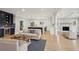 Open-concept living room featuring a wet bar, modern lighting, and an open floor plan at 1059 Woodland Ave, Atlanta, GA 30316