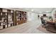 Bright home office featuring hardwood floors, built-in bookcases, a modern desk and chair, and recessed lighting at 1059 Woodland Ave, Atlanta, GA 30316