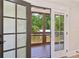 View of the back yard and wooden patio through a sliding door at 1059 Woodland Ave, Atlanta, GA 30316