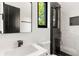 Modern bathroom featuring sleek fixtures, a stylish mirror, and a beautiful tiled shower with a window view at 187 Clay Se St, Atlanta, GA 30317