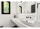Modern bathroom features a sleek white vanity, black fixtures, and a large mirror, offering a clean and stylish design at 187 Clay Se St, Atlanta, GA 30317
