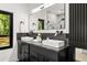Modern bathroom features a double vanity with marble countertops and sleek fixtures, plus a marble shower at 187 Clay Se St, Atlanta, GA 30317