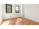 Bright, empty bedroom with hardwood floors and a view from two windows at 187 Clay Se St, Atlanta, GA 30317
