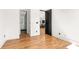 Bright bedroom with hardwood floors and an open doorway leading to an ensuite bathroom and kitchen views at 187 Clay Se St, Atlanta, GA 30317